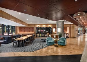 a lobby of a hotel with tables and chairs at The Rally Hotel at McGregor Square in Denver