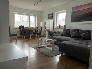 a living room with a couch and a table at FeWo an der Nordseeküste mit Garage in Wilhelmshaven