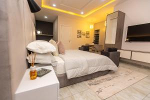 a bedroom with a bed and a living room at Majestic 4-Bedroom in Lagos in Lagos