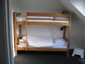 two bunk beds in a room with a staircase at Fuglevænget in Hundested