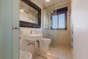Un baño con inodoro, lavabo y espejo. en Apartamento Talaia by MarCalma, en Mont-roig 20 fotos más