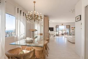 comedor y sala de estar con lámpara de araña en Apartamento Talaia by MarCalma, en Mont-roig