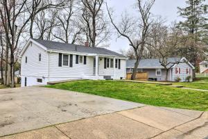 a white house with a yard and a driveway at Spacious Fort Washington Home Near National Mall! in Fort Washington