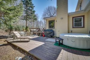 a large tub sitting on a deck next to a house at Pocono Summit Vacation Rental with Grill and Fire Pits in Pocono Summit