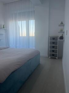a bedroom with a bed and a dresser and a window at Panorama 901 in Oradea