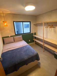 a bedroom with a bed and a bunk bed and a window at Casa de Dora in São Miguel dos Milagres