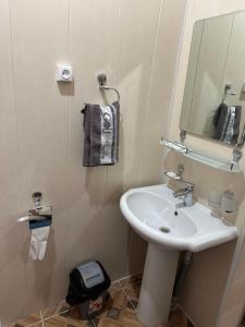 a bathroom with a sink and a mirror at TEMUR Hotel in Bukhara