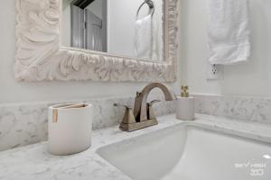 a white bathroom with a sink and a mirror at Alyce Retreat - Nature, Trails and Lake Escape in Bella Vista +31 photos