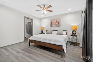 a bedroom with a bed and a ceiling fan at Alyce Retreat - Nature, Trails and Lake Escape in Bella Vista