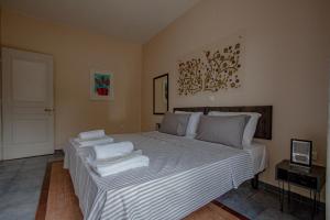 a bedroom with a bed with white towels on it at Mouse House in Gouvia +27 photos
