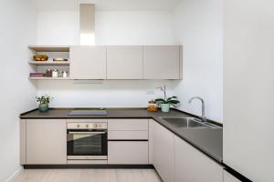 a kitchen with white cabinets and a sink at Apartment Klara in Krk