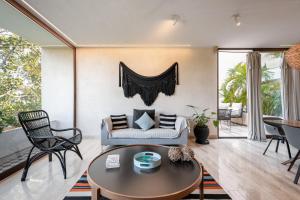 a living room with a couch and a table at 308-303 Beautiful apartments with 3 bedrooms in Tulum
