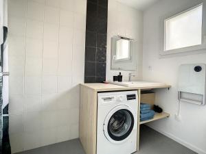 a bathroom with a washing machine and a sink at Maison cosy calme CARQUEFOU parking inclus in Carquefou