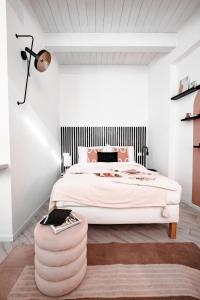 a bedroom with a large bed with a large ottoman at HYGGE APT - FERRARA CENTRO in Ferrara