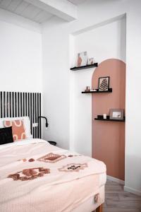 a bedroom with a bed with a black and white headboard at HYGGE APT - FERRARA CENTRO in Ferrara