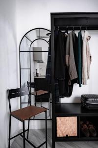 a black closet with a mirror and a chair at HYGGE APT - FERRARA CENTRO in Ferrara
