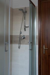 a shower in a bathroom with a glass door at Mufasa B&B in Soverato Marina