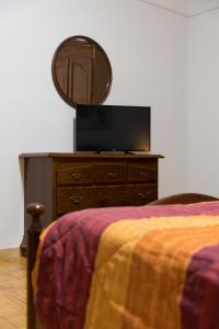 ein Schlafzimmer mit einem Bett und eine Kommode mit einem Spiegel in der Unterkunft Mufasa B&B in Soverato Marina