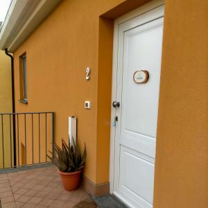 a door of a house with a clock on it at Casa Moki in Uliveto Terme