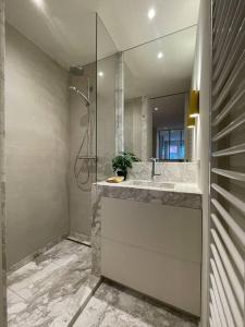 a bathroom with a sink and a mirror at Studio KZ modern studio in Knokke-Heist
