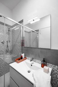 a bathroom with a white sink and a shower at HYGGE APT - FERRARA CENTRO in Ferrara