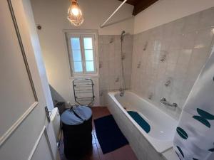 ein Bad mit einer Badewanne und einem Fenster in der Unterkunft Gîte campagnart 