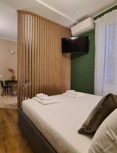 a bedroom with two beds and a green wall at Serendipity Apartments - Brera in Milan