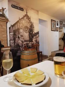 a table with a plate of cheese and a glass of wine at Casa Juanma in Córdoba