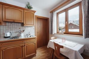 cocina con mesa, fregadero y ventana en Appartement Leni Leogang en Leogang