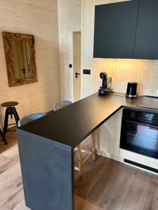 a kitchen with a black counter top in a room at Apartmán Tri Smreky Demänovská Dolina in Belá