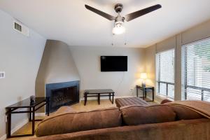 a living room with a couch and a fireplace at Golden Oasis, Unit #110 in Scottsdale