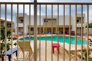 a view of a pool through a fence at Golden Oasis, Unit #110 in Scottsdale