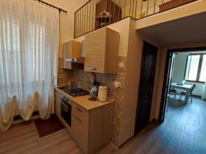 a kitchen with a stove and a sink in it at Lo Stemma Guest House in Melfi