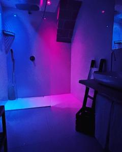 a room with pink and blue lights in a room at Recinto antico Sweet Rooms in Matera