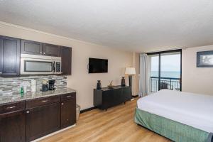a hotel room with a bed and a view of the ocean at Sun N Sand 607 in Myrtle Beach