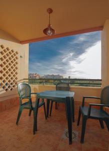 a table and chairs on a balcony with a view at Apartment Isla Canela Luxury in Huelva