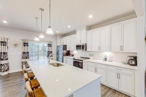 a kitchen with white cabinets and a white counter top at A Home Away from Home in North Myrtle Beach