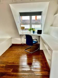 a desk with a chair in a room with a window at Charming central 3 Bed in Dublin