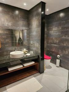 a bathroom with a sink and a toilet at Villa de rêve à Marrakech in Marrakech