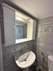 a bathroom with a sink and a mirror at Anatoli House in Gaios