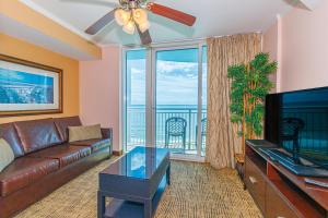 a living room with a couch and a flat screen tv at Towers On The Grove 724 Direct Oceanfront Suite Sleeps 6 guests in Myrtle Beach