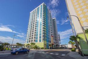 a blue car parked in front of a tall building at Towers On The Grove 724 Direct Oceanfront Suite Sleeps 6 guests in Myrtle Beach