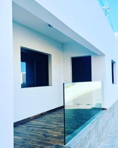 a room with two windows and a mirror on a wall at Bella Home in Garachico