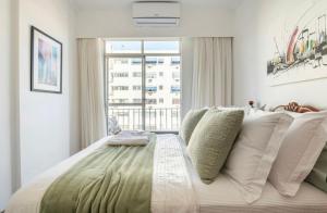 um quarto com uma cama grande e uma janela em Jacarepaguá Residence - Quarto em apartamento no Rio de Janeiro