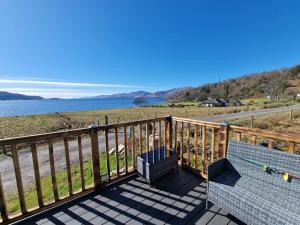 a balcony with a view of the water at Dalrigh Pod in Onich