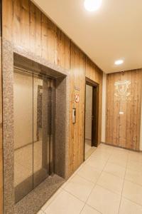 a hallway with a glass door in a building at Amman Sun Apartments in Ţāb Kirā‘