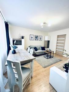 a living room with a table and a couch at Ogrodowy Apartament in Sandomierz
