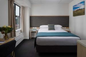 a hotel room with a bed and a window at Atura Wellington in Wellington