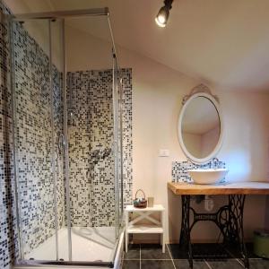 a bathroom with a shower with a sink and a mirror at B&b 500' in Nogaredo Al Torre