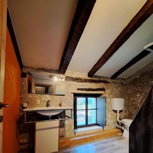 a bathroom with a sink and a toilet and a window at B&b 500' in Nogaredo Al Torre